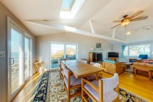 a dining room with a table and chairs and a ceiling fan at Beaches n' Sunsets in Eastham