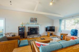a living room with a couch and a fireplace at Beaches n' Sunsets in Eastham
