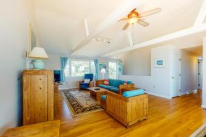 a living room with a couch and a ceiling fan at Beaches n' Sunsets in Eastham +26 photos