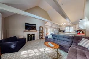 a living room with a couch and a table at Sit Back & Relax in Eastham