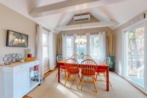 a dining room with a red table and chairs at Sit Back & Relax in Eastham