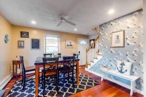 a dining room with a blue wall with birds on it at Brewster House in Oak Bluffs