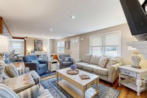 a living room with a couch and a table at Cape Cod Playhouse in Yarmouth