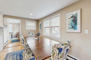 a dining room with a wooden table and chairs at Cape Cod Playhouse in Yarmouth