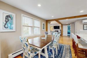 a dining room with a wooden table and chairs at Cape Cod Playhouse in Yarmouth