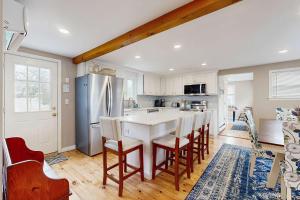a kitchen with a table and chairs and a refrigerator at Cape Cod Playhouse in Yarmouth