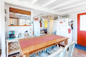 a kitchen with a table and a refrigerator at Dunes Edge in Wellfleet