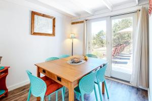 a dining room with a wooden table and chairs at Dunes Edge in Wellfleet +18 photos