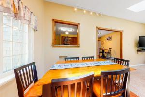 a dining room with a wooden table and chairs at Mattakeese Villa in Yarmouth