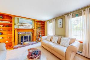 a living room with a couch and a fireplace at Mattakeese Villa in Yarmouth +18 photos