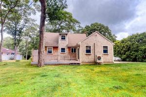 a house with a tree in a yard at Lake Shore Living in Falmouth