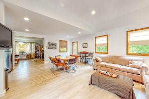 a living room with a couch and a table at Lake Shore Living in Falmouth