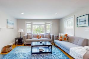 a living room with two couches and a coffee table at Ocean Bird Nest in South Yarmouth