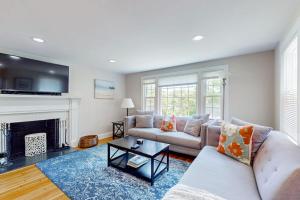 a living room with a couch and a fireplace at Ocean Bird Nest in South Yarmouth
