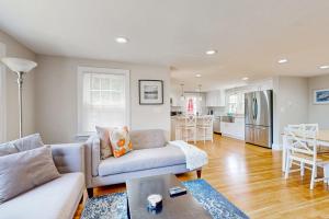 a living room with a couch and a kitchen at Ocean Bird Nest in South Yarmouth