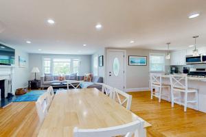 a kitchen and living room with a wooden table and chairs at Ocean Bird Nest in South Yarmouth +16 photos