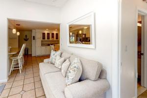 a living room with a couch and a kitchen at Sea You Later in West Yarmouth