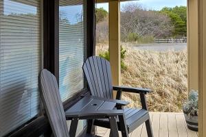 two chairs sitting on the porch of a house at Ships Ahoy in Truro