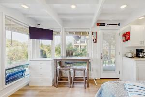a kitchen with a table and chairs in a room at Ships Ahoy in Truro