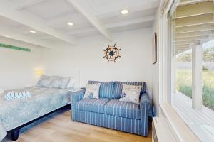 a living room with a couch and a window at Ships Ahoy in Truro