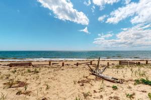 a beach with a wooden fence and the ocean at Ships Ahoy in Truro