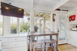 a kitchen with a table and two stools at Ships Ahoy in Truro +18 photos