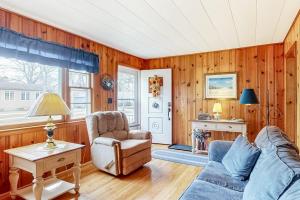 a living room with a couch and a chair at Anchors Await in South Yarmouth