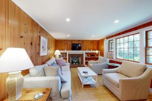 a living room with a couch and chairs and a fireplace at Sweet Victory in Harwich Port +14 photos