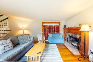 a living room with a couch and a fireplace at Dream Dennis Getaway in Dennis