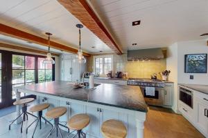 a kitchen with a large island with bar stools at The Long Fox in Provincetown