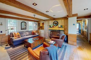 a living room with a couch and a fireplace at The Long Fox in Provincetown