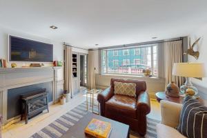 a living room with a couch and a fireplace at The Long Fox in Provincetown