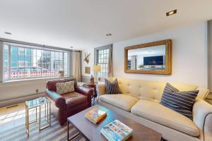 a living room with a couch and a table at The Long Fox in Provincetown +24 photos