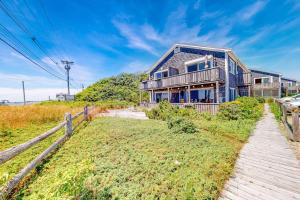 a house on a hill with a wooden walkway at Bay Colony Vista in Provincetown