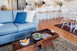 a living room with a blue couch and a table at Barnstable Harbor Home in Barnstable