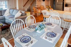 a dining room with a white table and chairs at Barnstable Harbor Home in Barnstable +24 photos