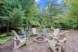 a group of chairs sitting around a fire pit at Between the Lakes in Glen Arbor