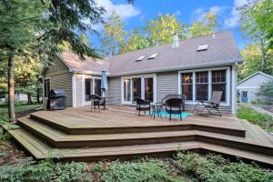 a wooden deck in front of a house at Between the Lakes in Glen Arbor