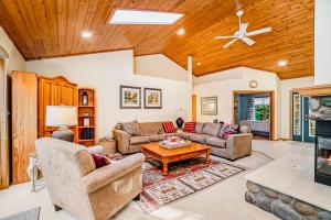a living room filled with furniture and a wooden ceiling at Between the Lakes in Glen Arbor