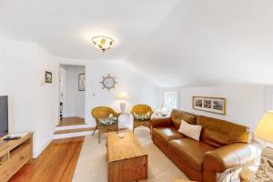 a living room with a couch and a table at Everyday is Saturday in Vineyard Haven