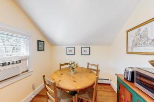 a dining room with a table and a microwave at Everyday is Saturday in Vineyard Haven