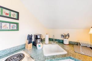 a kitchen counter with a sink and a coffee maker at Everyday is Saturday in Vineyard Haven +14 photos