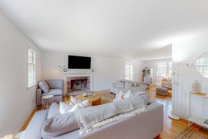 a living room with two couches and a fireplace at New England Getaway in Dennis