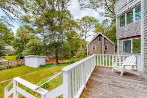 a wooden deck with a bench and a house at Lake Elizabeth Terrace in Centerville