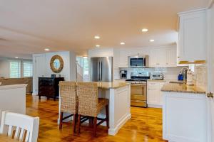 a kitchen with white cabinets and a table and chairs at Lake Elizabeth Terrace in Centerville