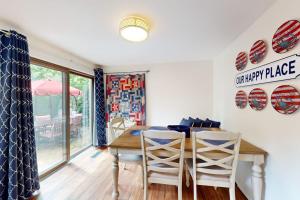 a dining room with a table and chairs at South Cape Escape in Mashpee