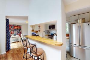 a kitchen with a counter and a refrigerator at South Cape Escape in Mashpee