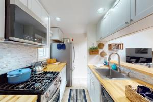 a kitchen with a stove and a sink at South Cape Escape in Mashpee +11 photos