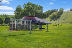 a park with a playground in the grass at Boyne Mountain Getaway, Unit B in Boyne Falls