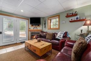 a living room with a couch and a coffee table at Boyne Mountain Getaway, Unit B in Boyne Falls